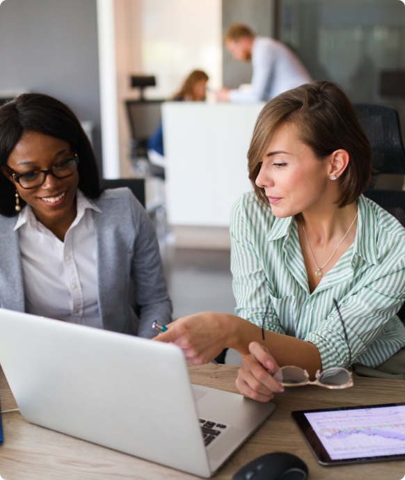 two women collaborating on a computer